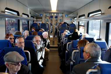 Travelers wait in their chairs for a maiden trip of the Trinity Metro TEXRail to go to DFW...