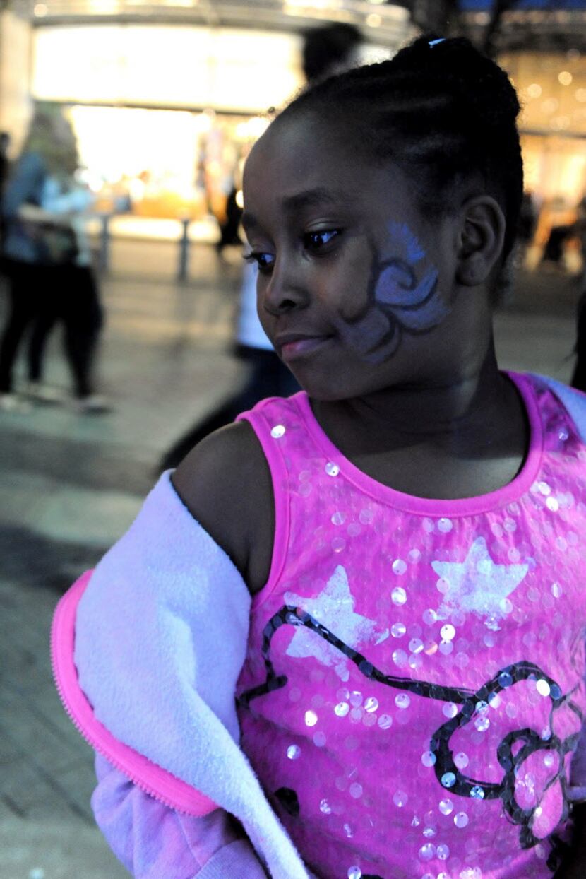 Serenity, 7, flaunts her freshly painted face at the annual Spring Block Party.