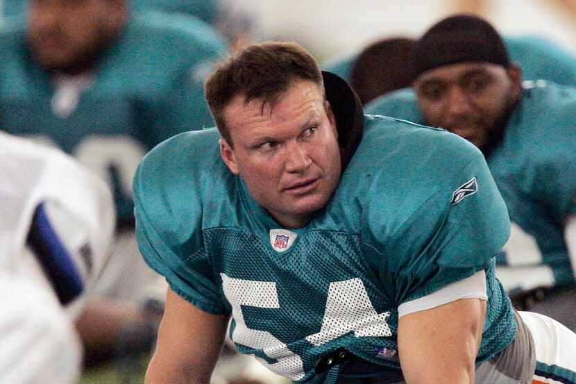 Miami Dolphins linebacker Zach Thomas stretches during NFL football training camp in Davie,...