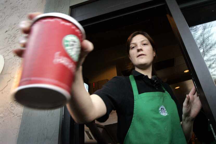 ORG XMIT: *S0415051794* Barista Heidi Krause passes a coffee drink out the window at a...