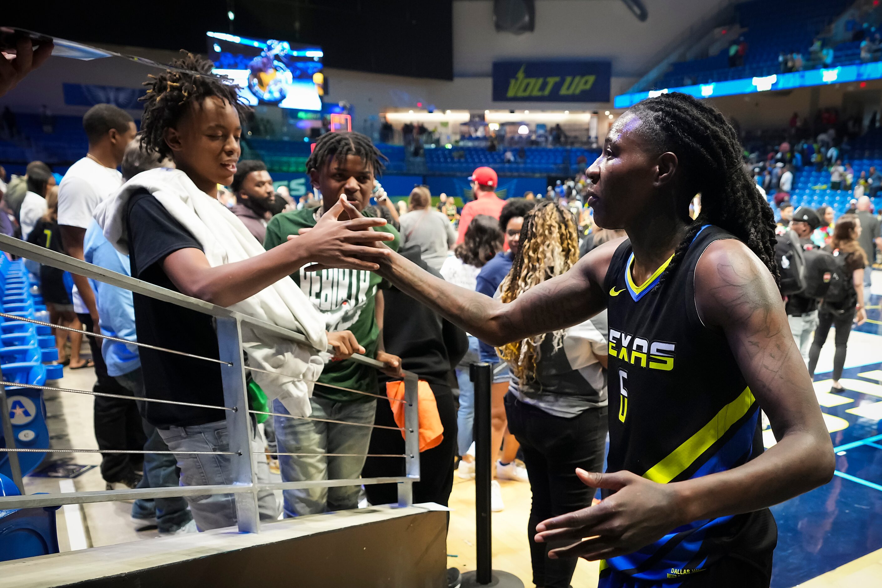 Dallas Wings forward Natasha Howard celebrates with fans after a victory over the Atlanta...