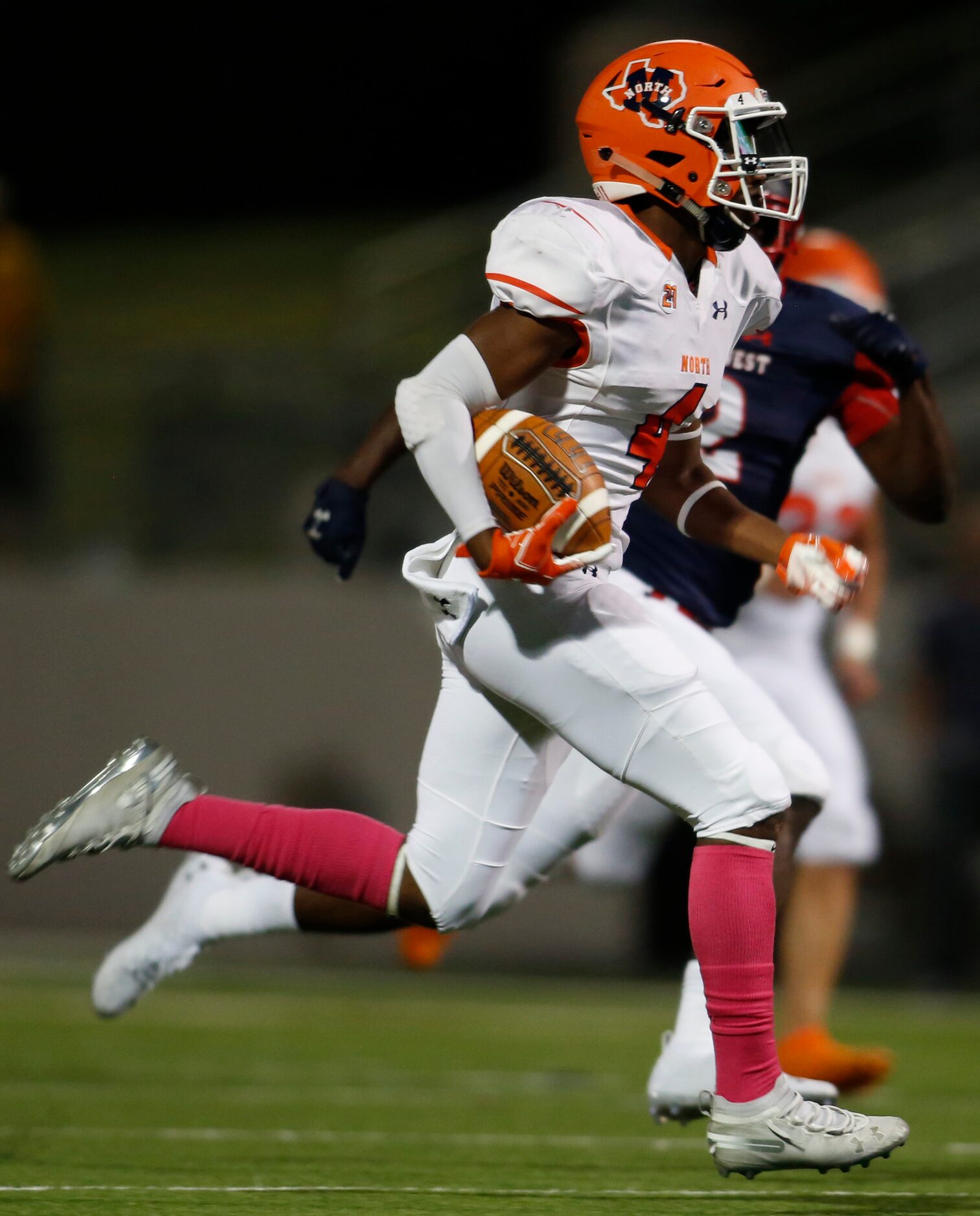 McKinney North defensive back Michael Norris (4) returns an interception for a touchdown as...