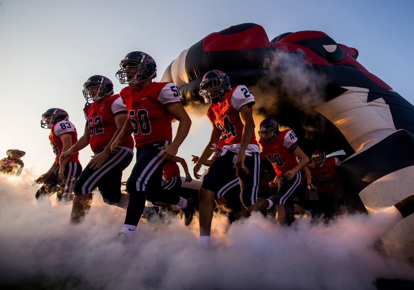 McKinney Boyd players enter the field before a high school football game between Lewisville...