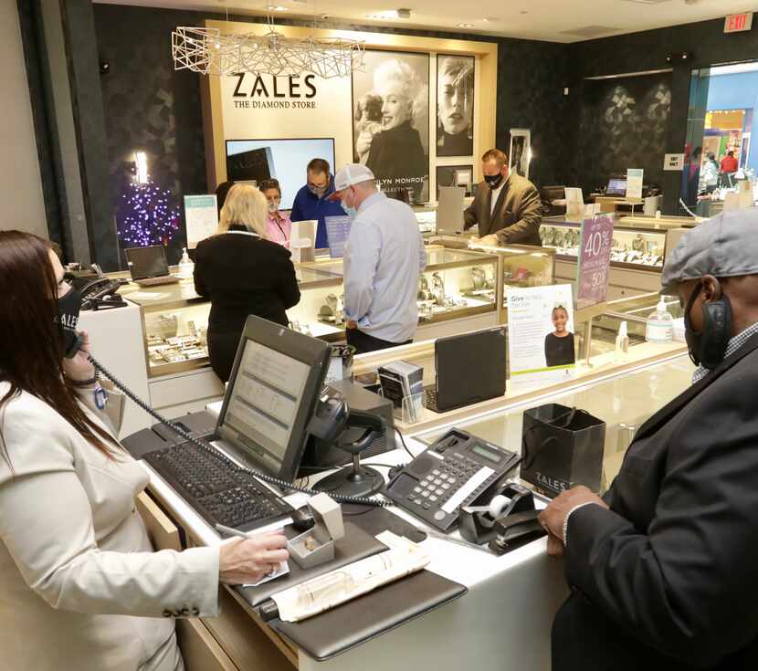 Customers browse the selection at the Stonebriar Centre Zales store in Frisco on Dec. 23.
