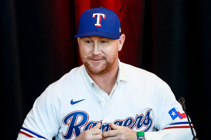 Kole Calhoun puts on his jersey at a news conference at Globe Life Park in Arlington on...