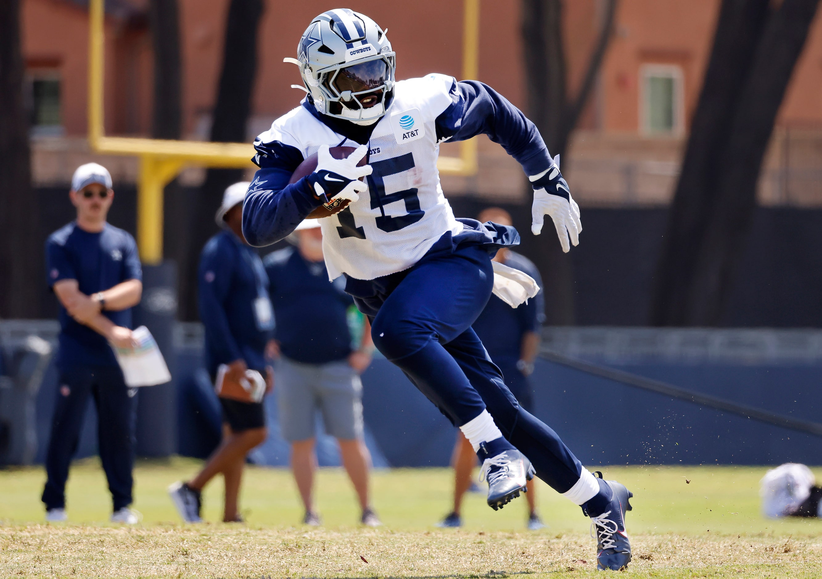 Dallas Cowboys running back Ezekiel Elliott (15) makes a cut after taking a hand off from...