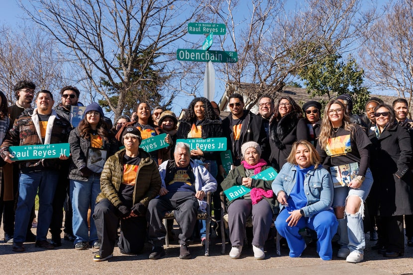 Family and friends of Raul Reyes Jr. pose for photos during a ceremony unveiling a street...