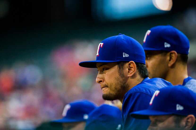 Texas Rangers starting pitcher Yu Darvish (11) watches from the dugout during the second...