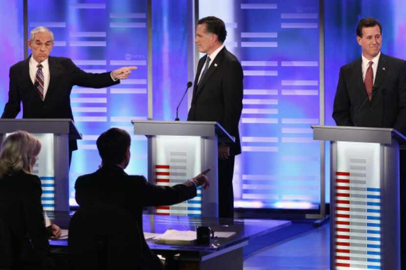 Ron Paul (left) pointed at Mitt Romney, but his blows were aimed much more at Rick Santorum...