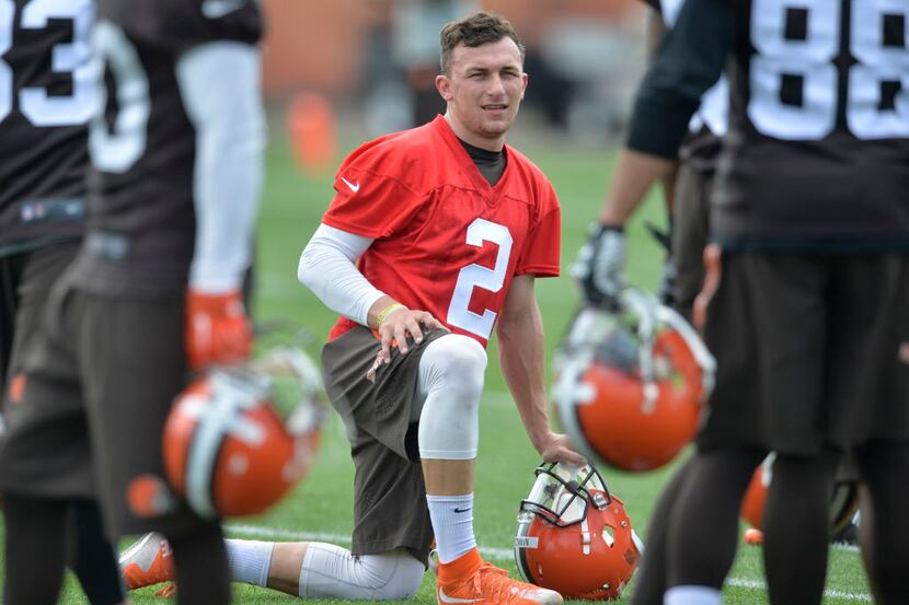 Cleveland Browns quarterback Johnny Manziel kneels on the field during an NFL football...