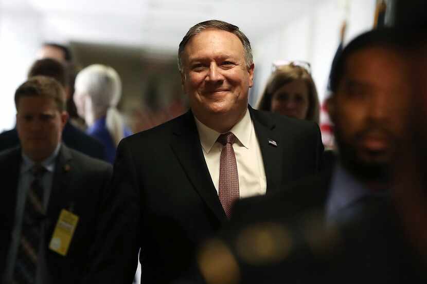 CIA Director Mike Pompeo smiles as he walks to a meeting with Sen. Mark Warner (D-VA) on...