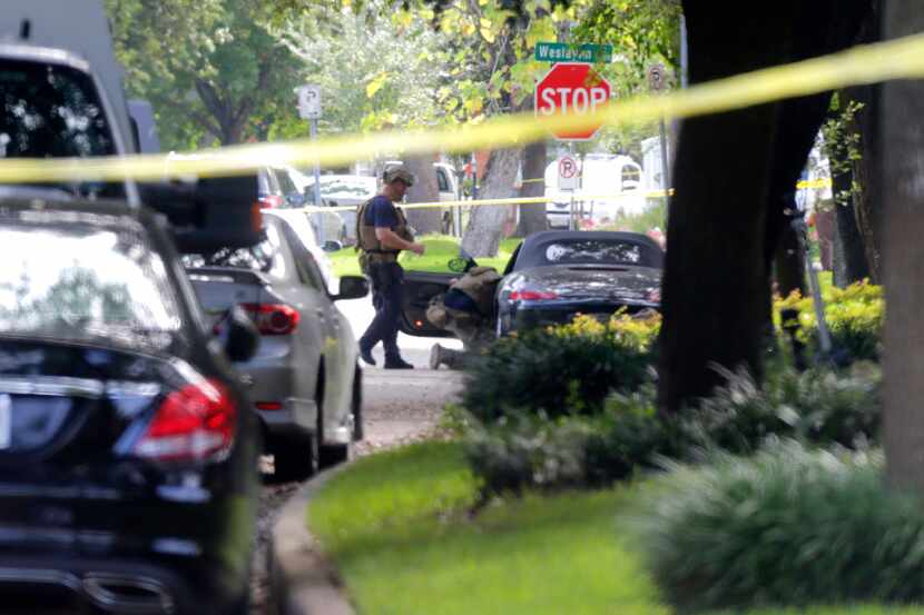 Police investigate the car believed to belong to the gunman at the scene of Monday's...