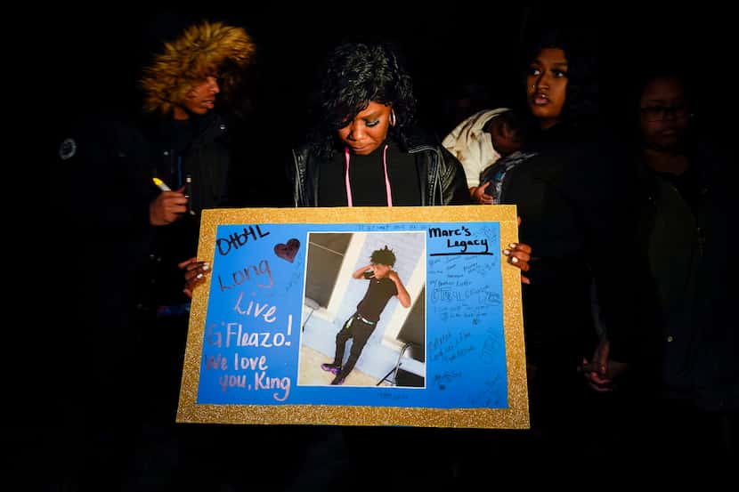 Monique Mitchell holds a photograph of her son Marc "Flea" Strickland, an 18-year-old victim...