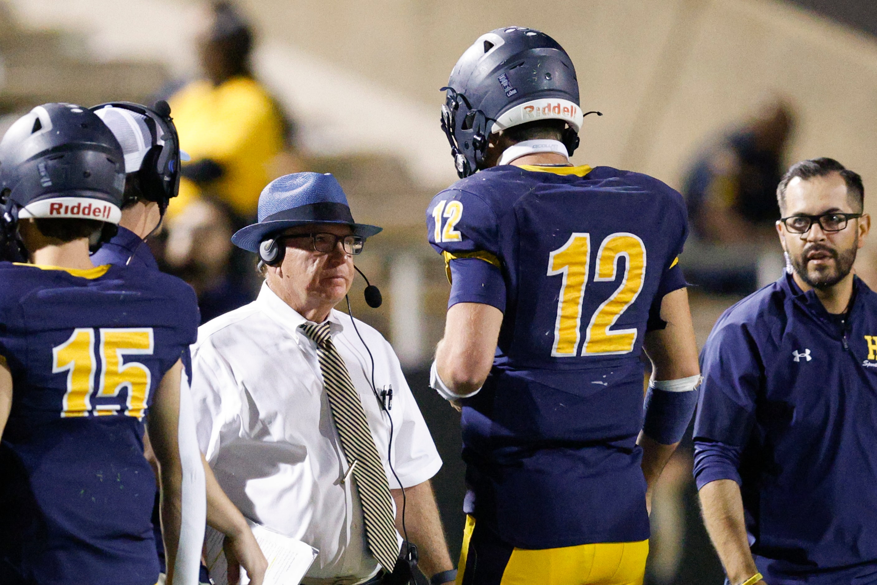 Highland Park head coach Randy Allen talks with quarterback Warren Peck (12) during the...