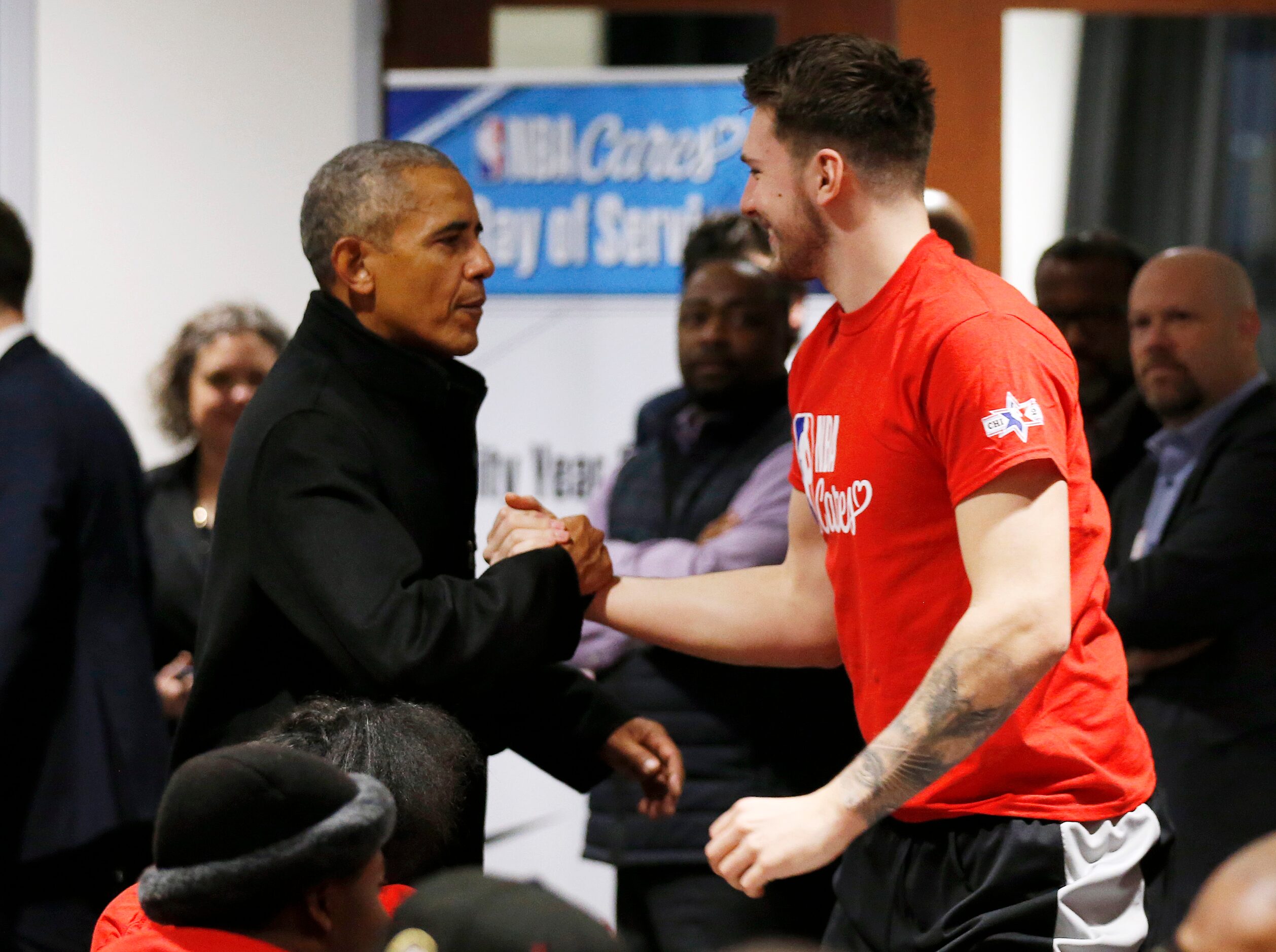 Former President Barack Obama greets Dallas Mavericks forward Luka Doncic (77) during a NBA...