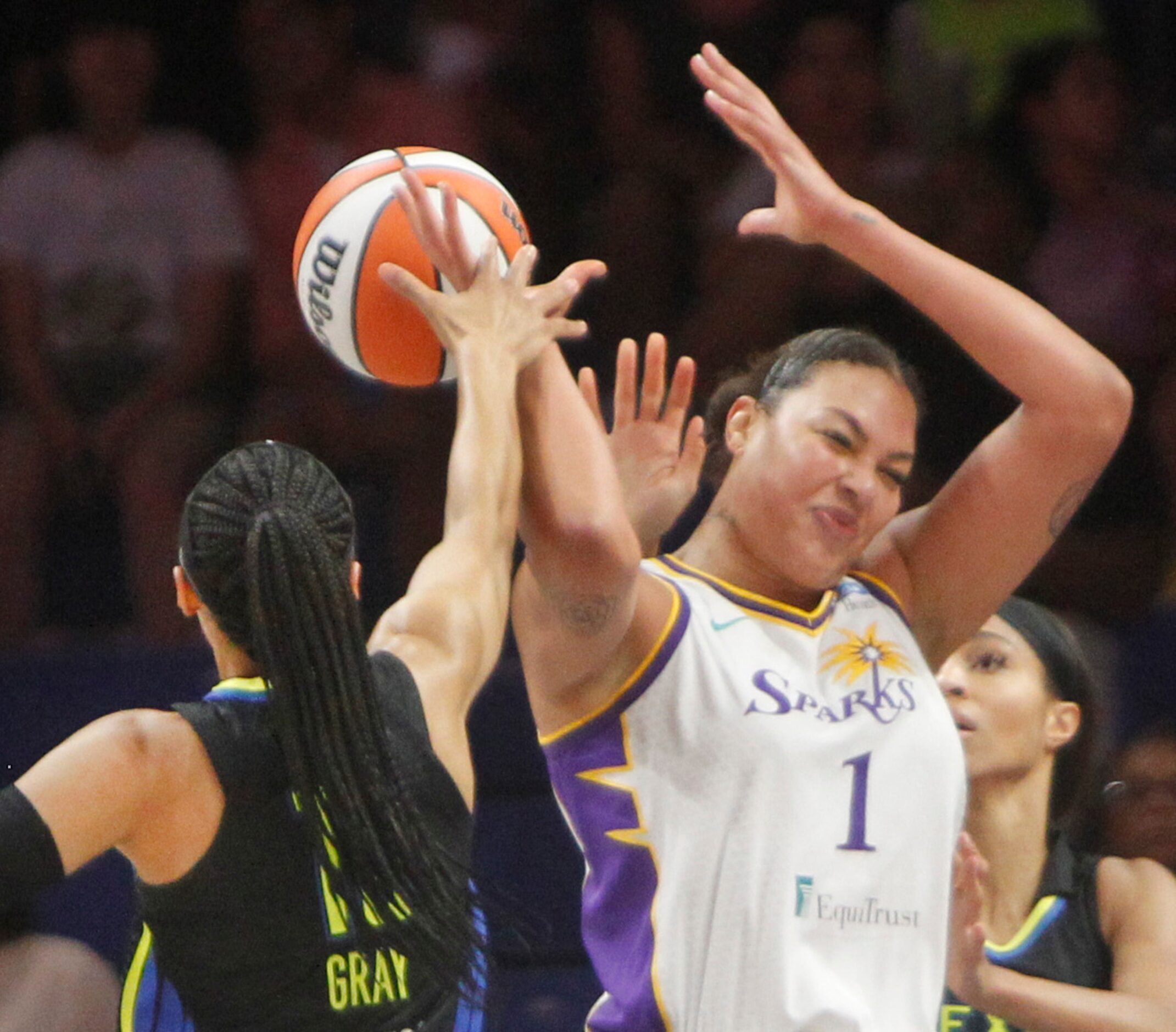 Dallas Wings guard Allisha Gray (15) blocks an attempted pass by LA Sparks center Liz...