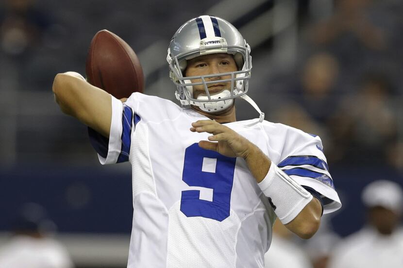 Dallas Cowboys quarterback Tony Romo (9) warms up before an NFL preseason football game...