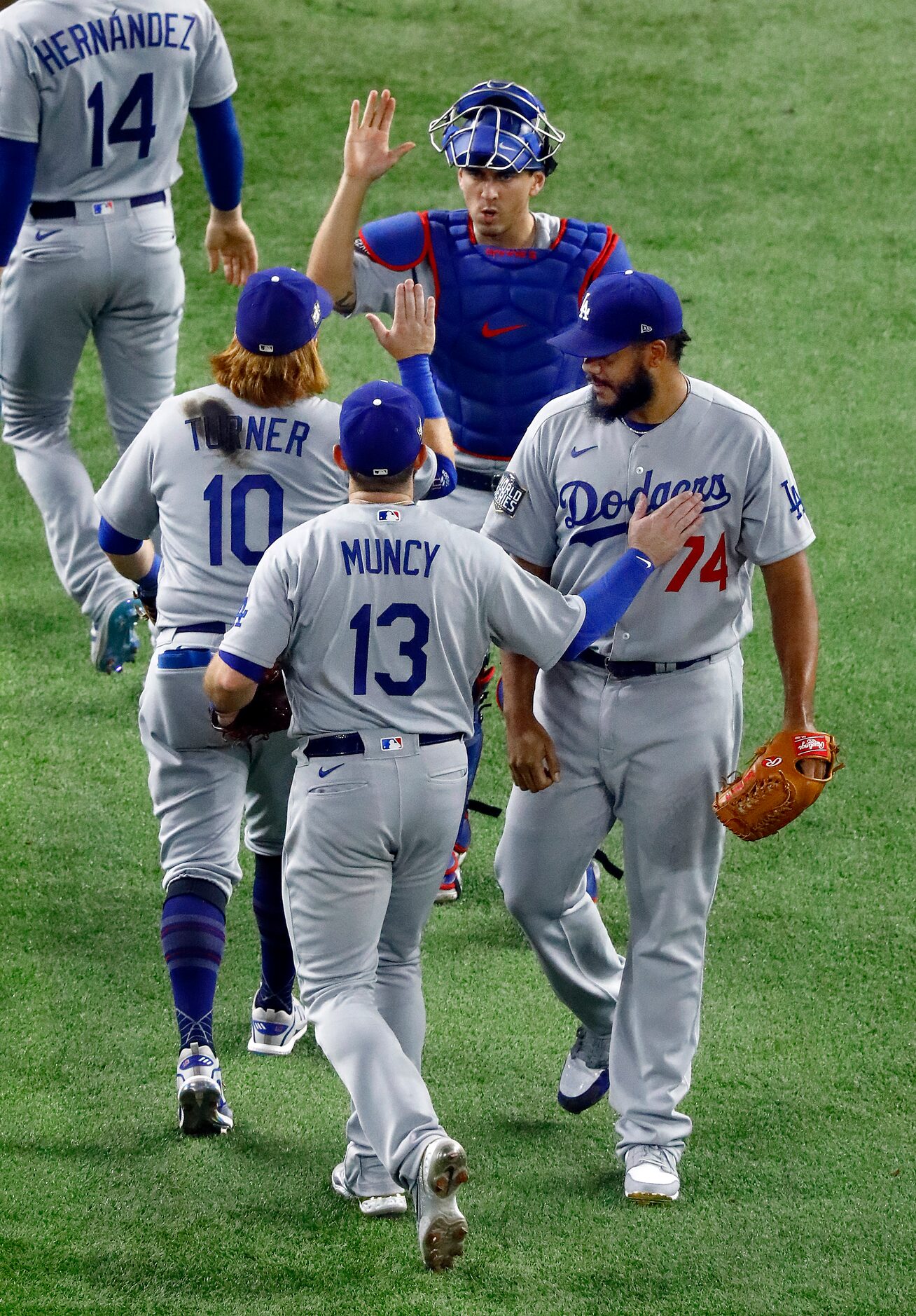 Los Angeles Dodgers first baseman Max Muncy (13) congratulates relief pitcher Kenley Jansen...