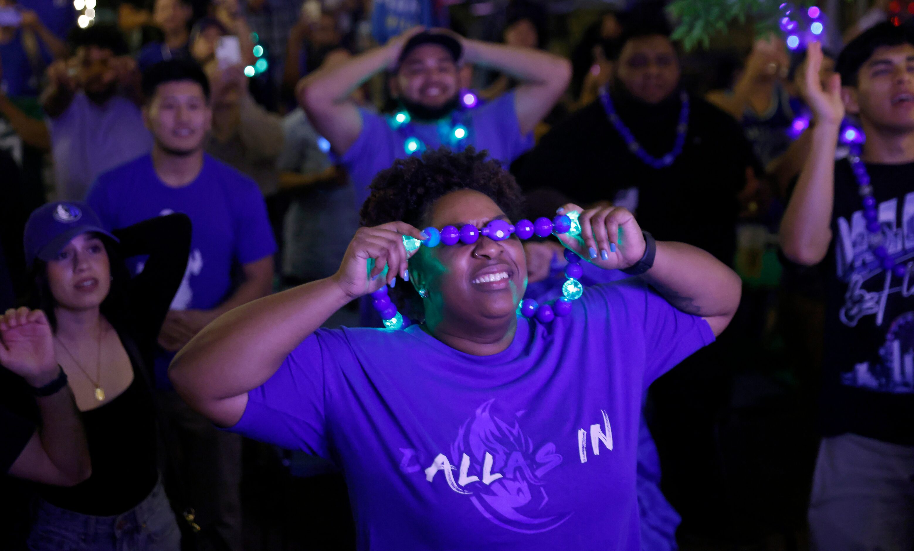 A Dallas Mavericks fan covers her eyes as the final seconds tick off their series win over...