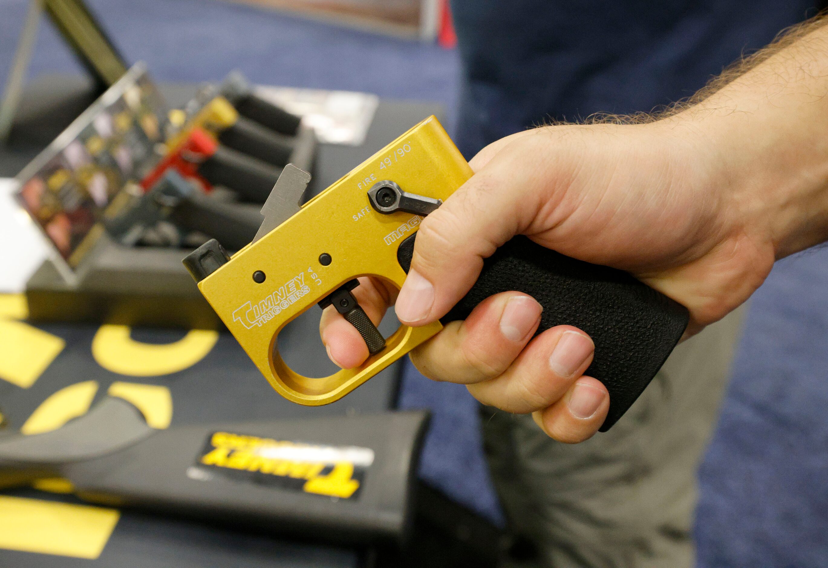 Richard Boughton of Dallas holds an AR tester at the Timney Triggers booth, during 2024 NRA...