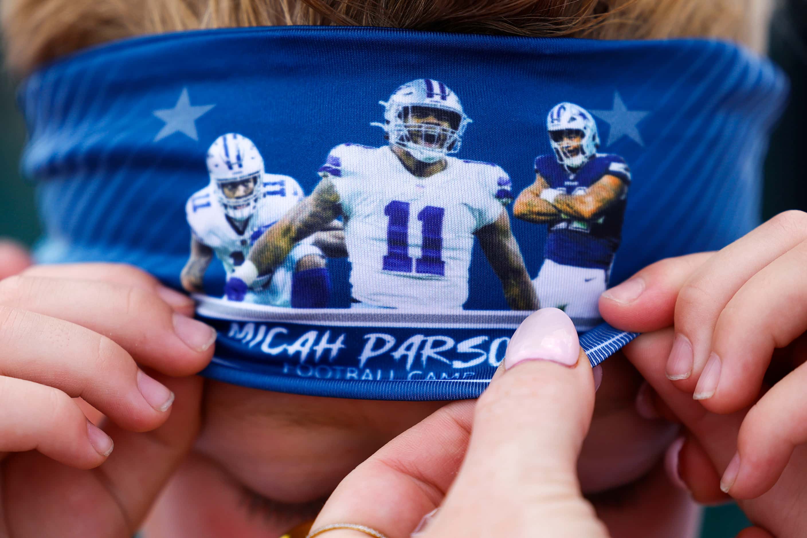 Oliver McGrath, 6, fixes his Dallas Cowboys linebacker Micah Parsons headband during player...