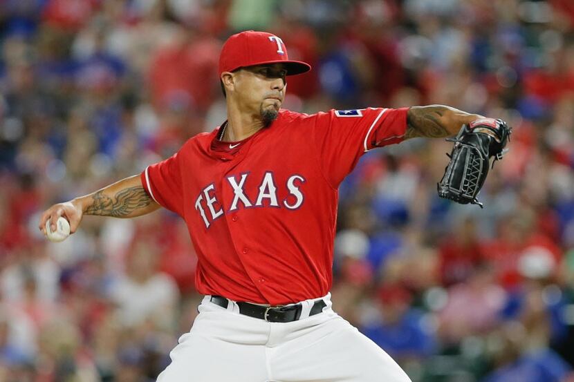 Texas Rangers starting pitcher Kyle Lohse throws during the first inning of a baseball game...
