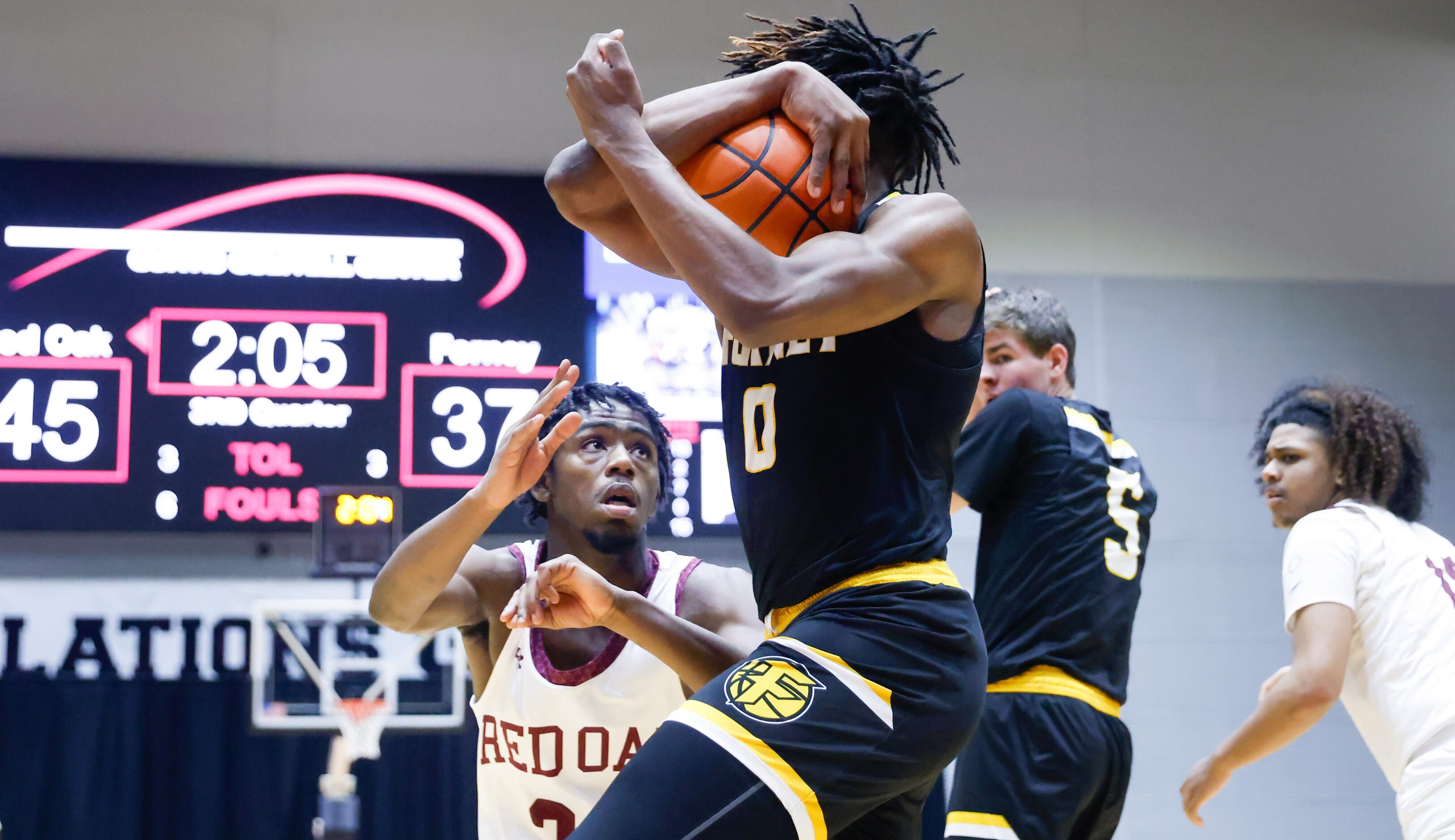 Red Oak junior guard Kamal Brooks (24, left) moves to guard Forney senior forward Ronnie...