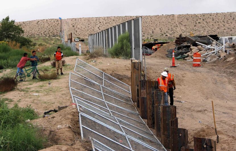 U.S. workers replaced fencing with a higher new metal wall along the border between Ciudad...