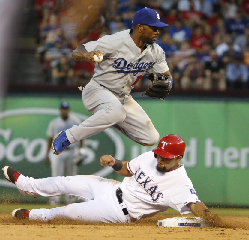 Texas second baseman Rougned Odor slides in hard at second to break up a double play, as...