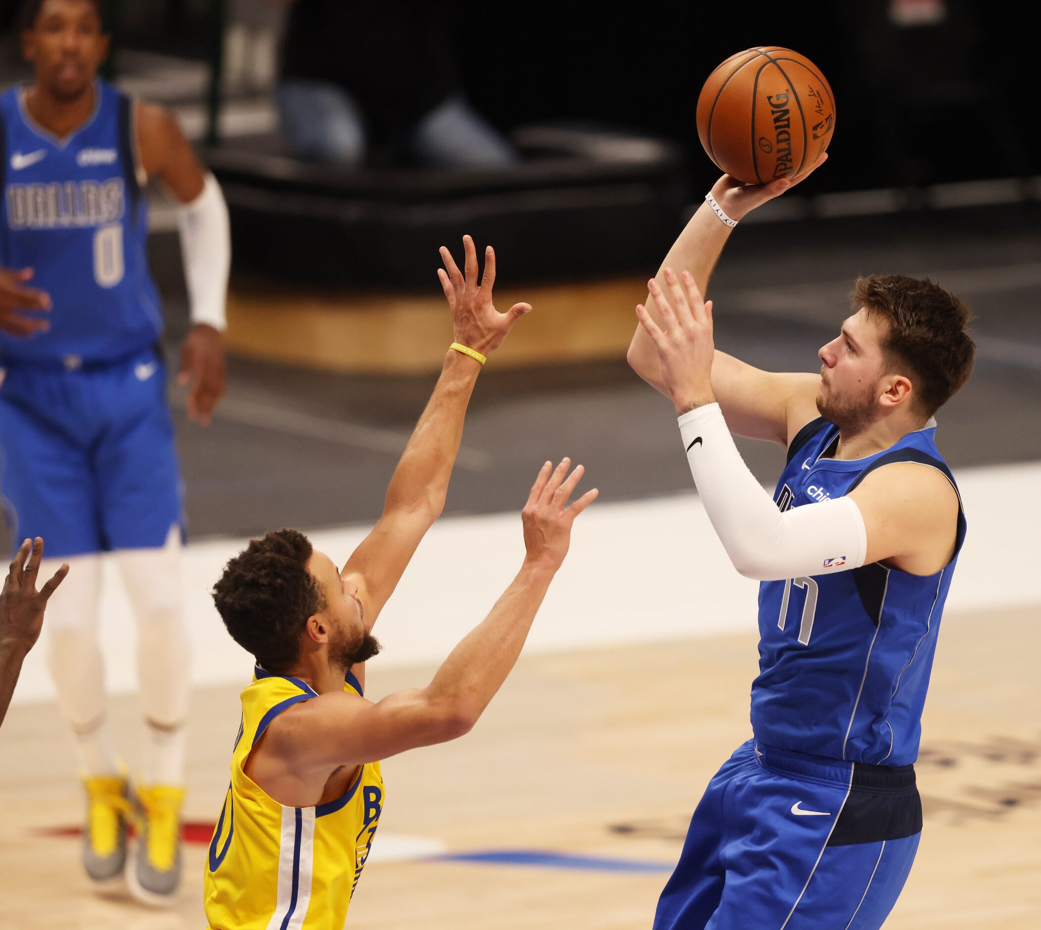 Dallas Mavericks guard Luka Doncic (77) shoots over Golden State Warriors guard Stephen...