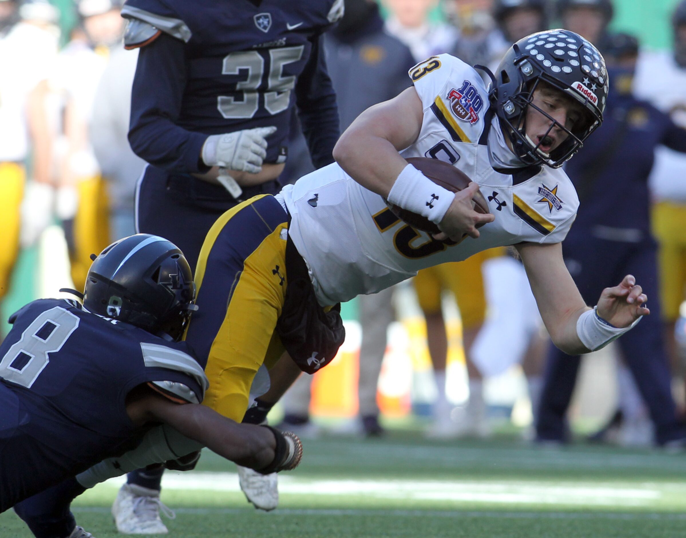 Highland Park quarterback Brayden Schager (13) lunges for extra yardage as Frisco Lone Star...