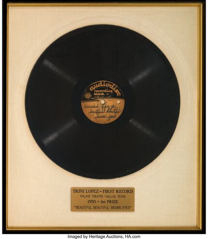 A framed acetate of Trini López’s first recording, “Beautiful, Beautiful Brown Eyes” is...