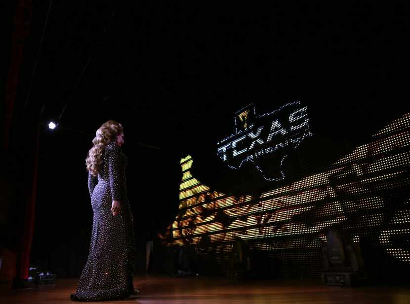 Rebekah Whitney Jackson walks across the stage in her evening gown during the Miss Gay Texas...