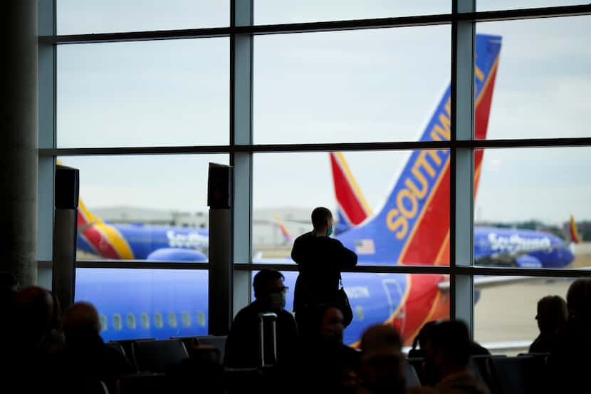 Passengers wait to board a Southwest Airlines flight at Dallas Love Field in January.