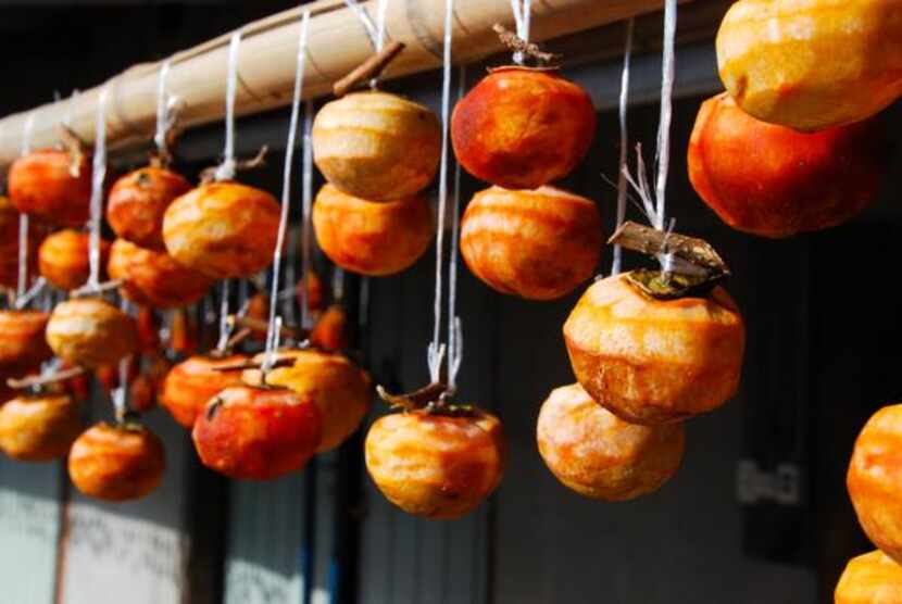 
Peeled persimmons are hung to dry in the sun outside a farmhouse on the Kunisaki Peninsula....
