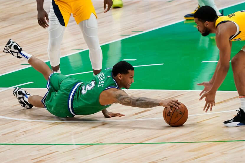 Dallas Mavericks guard Trey Burke (3) dives for a loos ball against Indiana Pacers guard...