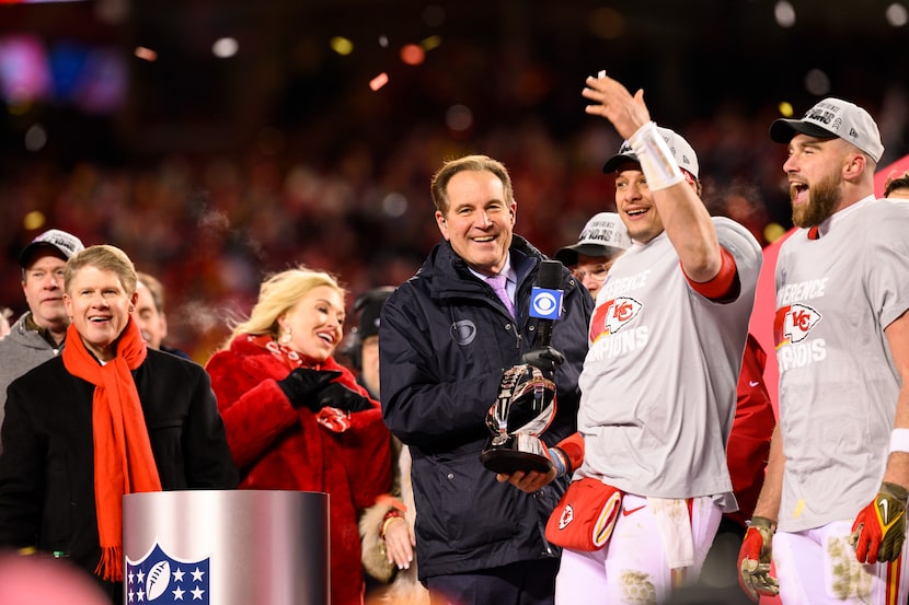 Kansas City Chiefs quarterback Patrick Mahomes, holding the Lamar Hunt Trophy, celebrates...