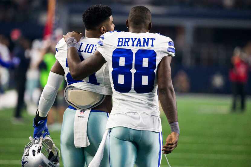 Dallas Cowboys wide receiver Dez Bryant (88) puts his arm around the shoulders of running...