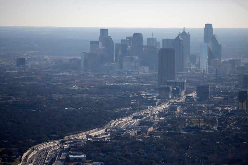 The air hangs with haze as traffic moves on Hwy. 75 Central Expressway.