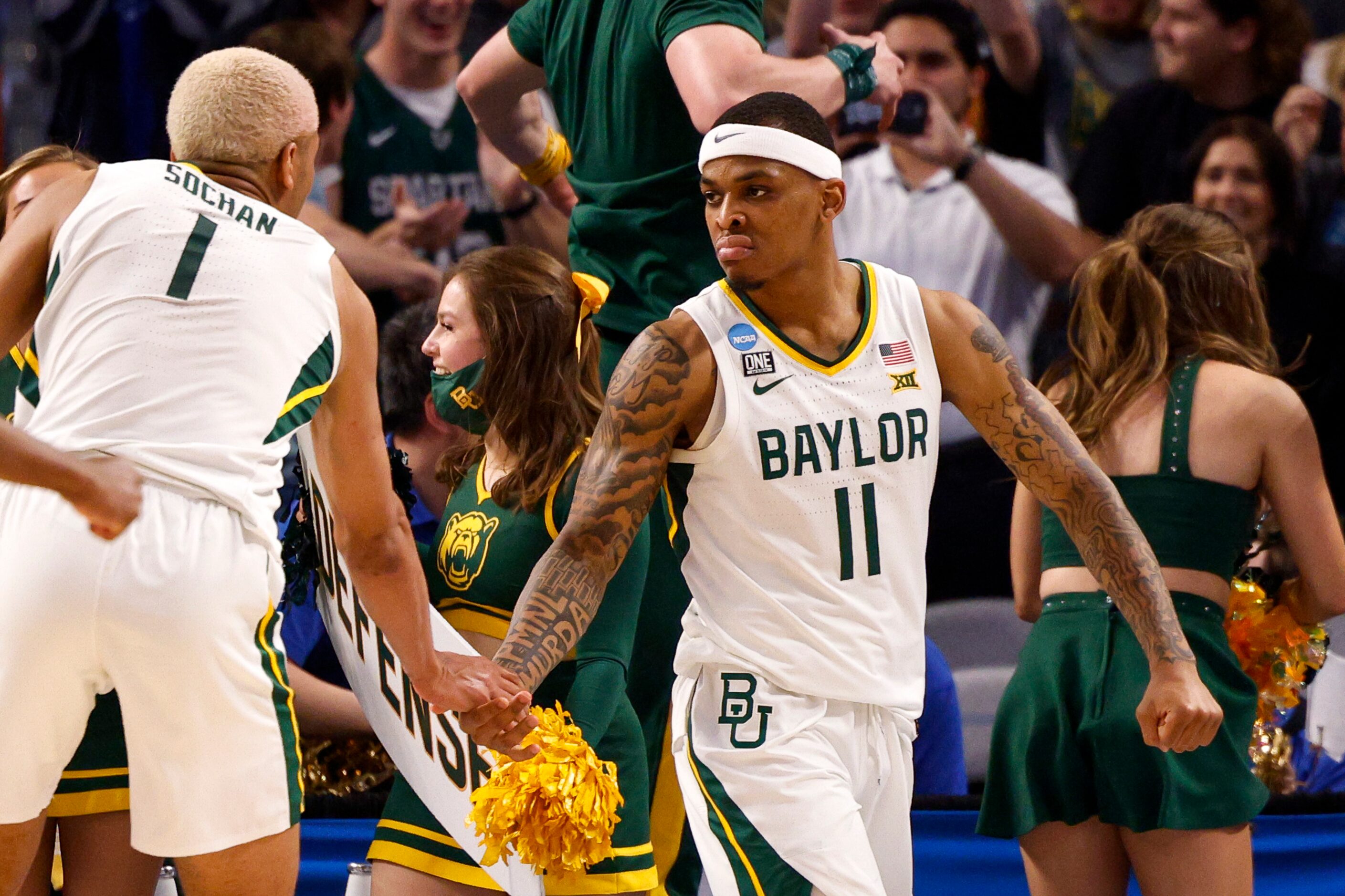 Baylor Bears guard James Akinjo (11) high-fives Baylor Bears forward Jeremy Sochan (1) after...