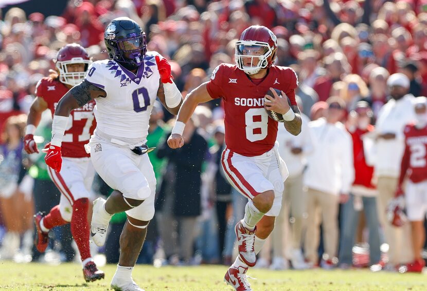 Oklahoma quarterback Dillon Gabriel (8) runs for a a first down ahead of TCU linebacker Shad...