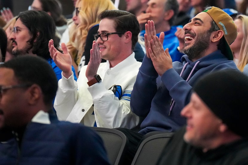 Parsa Bastami (right) cheers from the seats of his late friend Cody Ward before an NBA game...