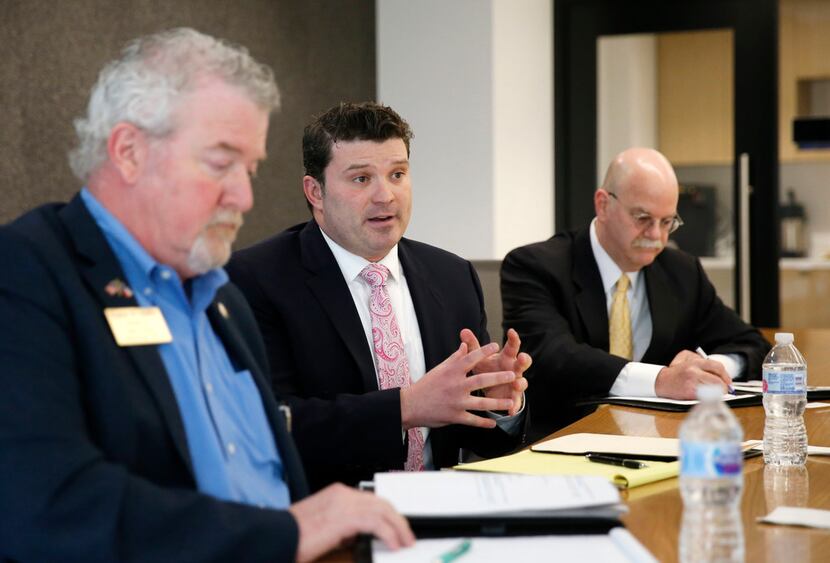 Dallas attorney J.J. Koch, center, answers questions in an editorial board meeting as former...