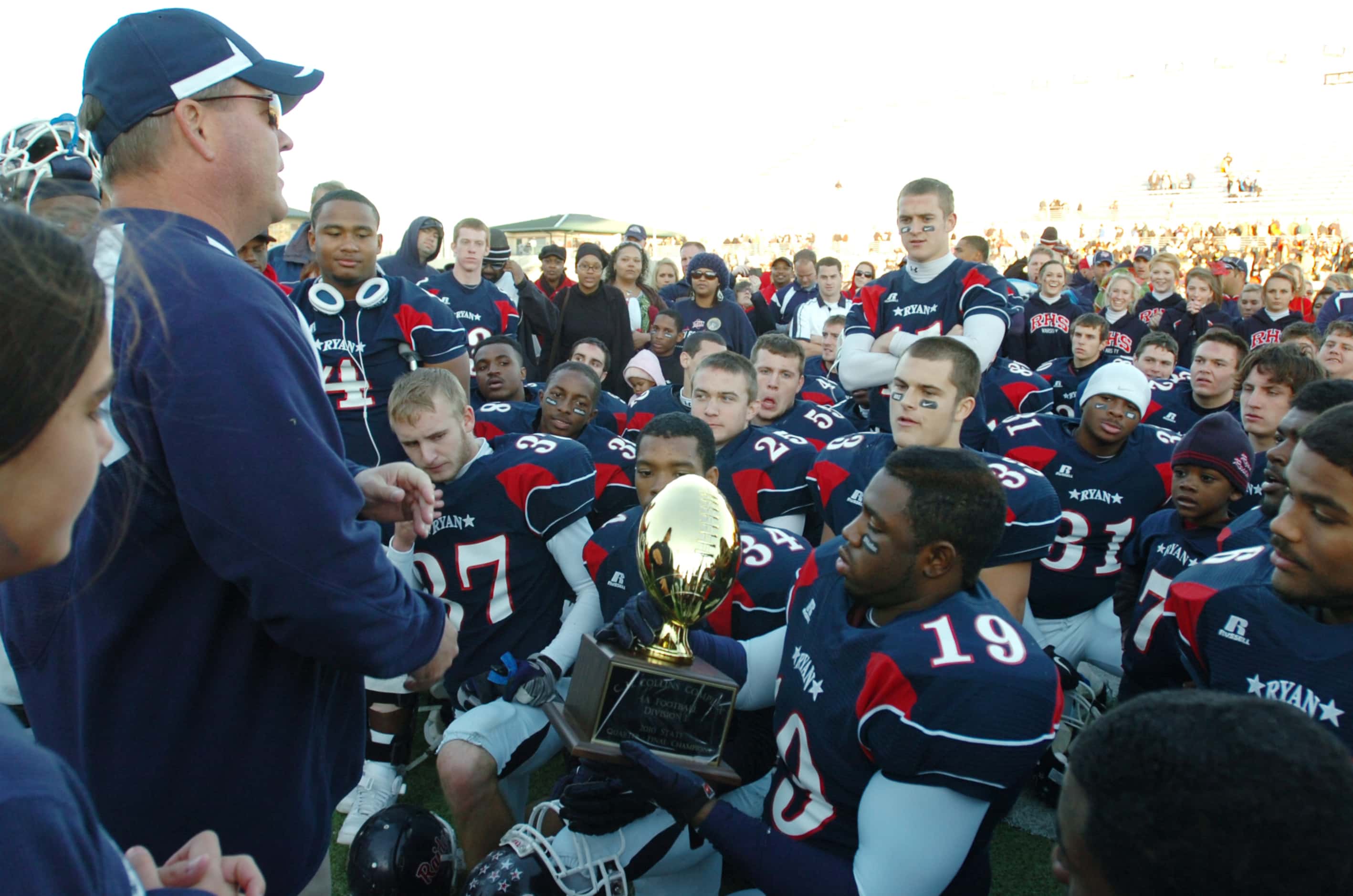 Denton Ryan coach Joey Florence speaks to his team after defeating Wichita Falls Rider in a...