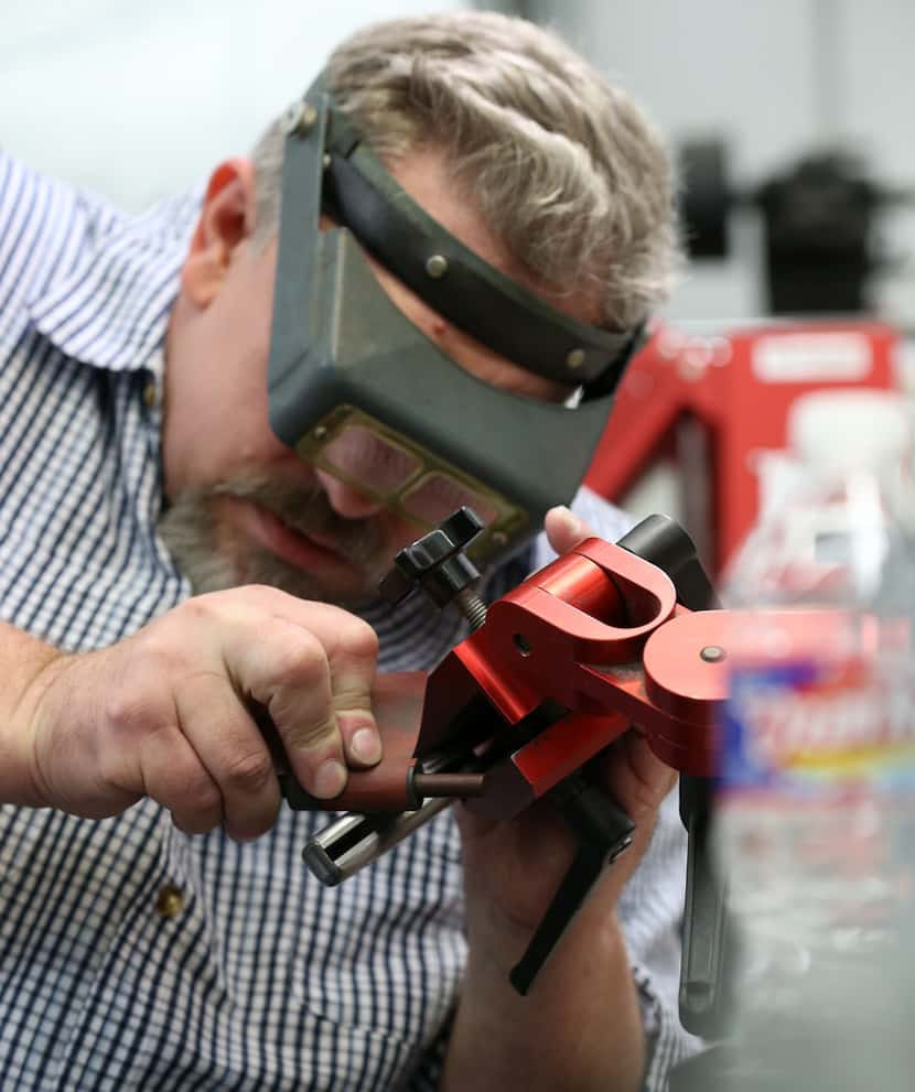 Todd Begg sands a knife at his shop in Dallas.