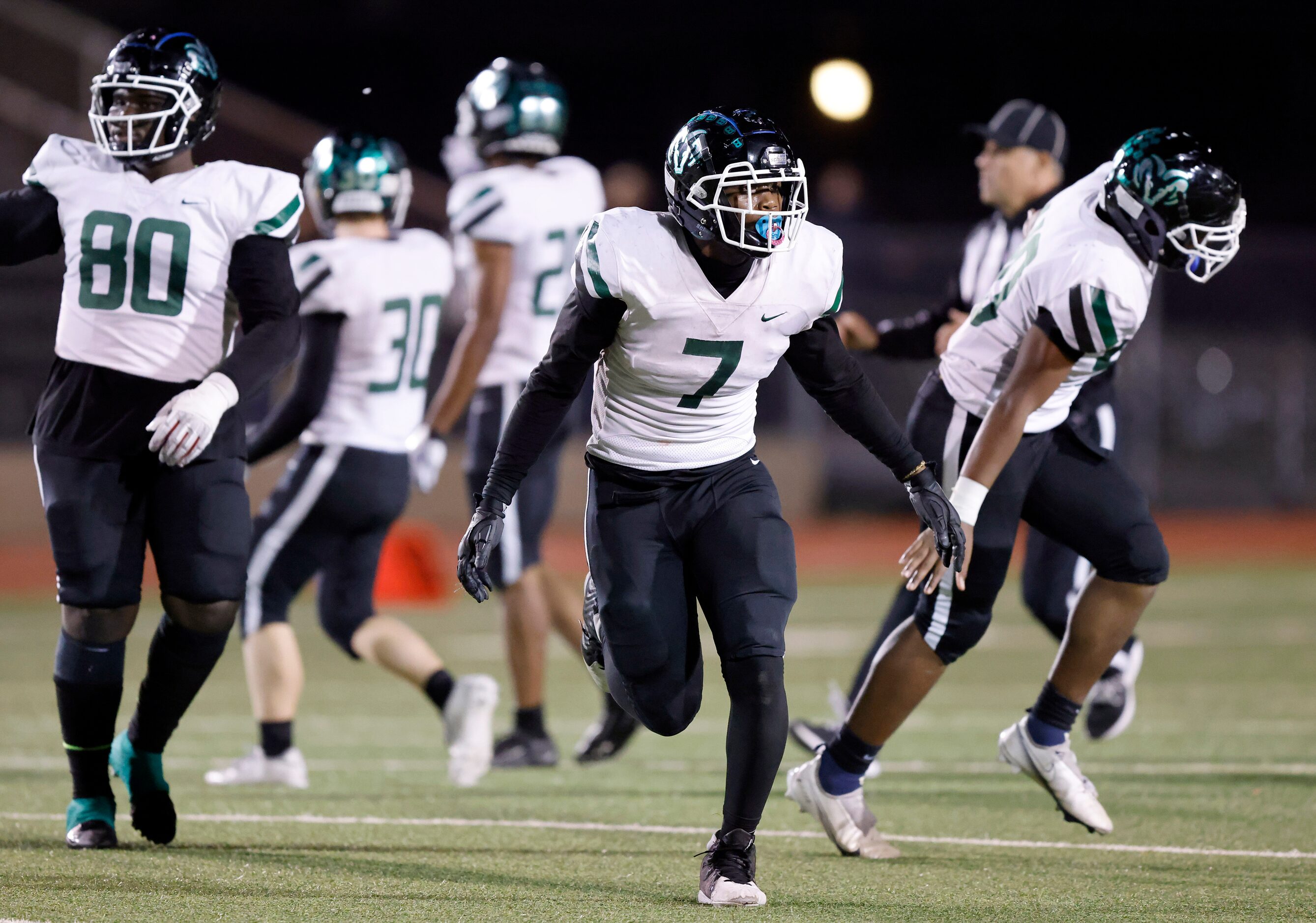 Richardson Berkner's Lemone Stewart (7) and the rest of the defense celebrate their 14-7 win...