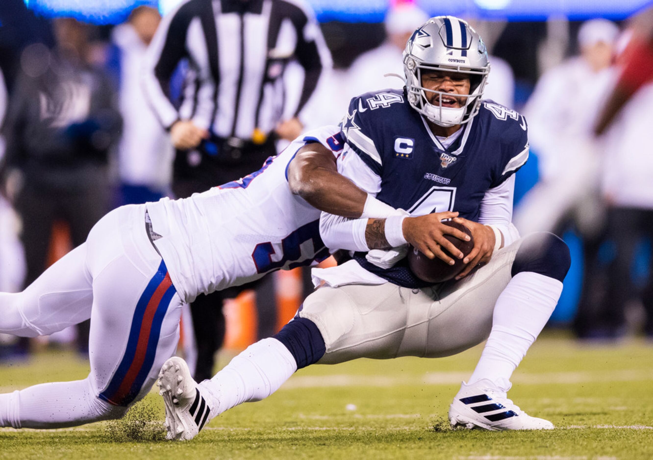 Dallas Cowboys quarterback Dak Prescott (4) is tackled by New York Giants linebacker Lorenzo...