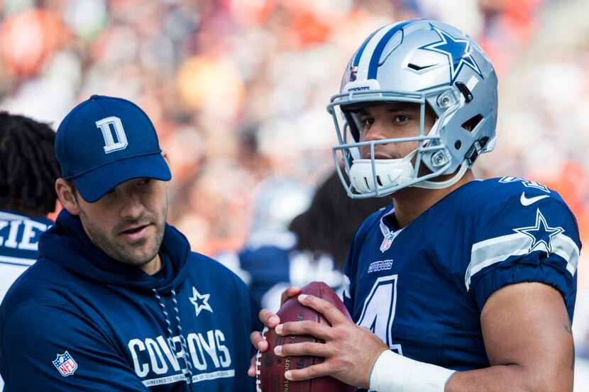 Dallas Cowboys quarterback Tony Romo (9) pats Dallas quarterback Dak Prescott (4) on the...