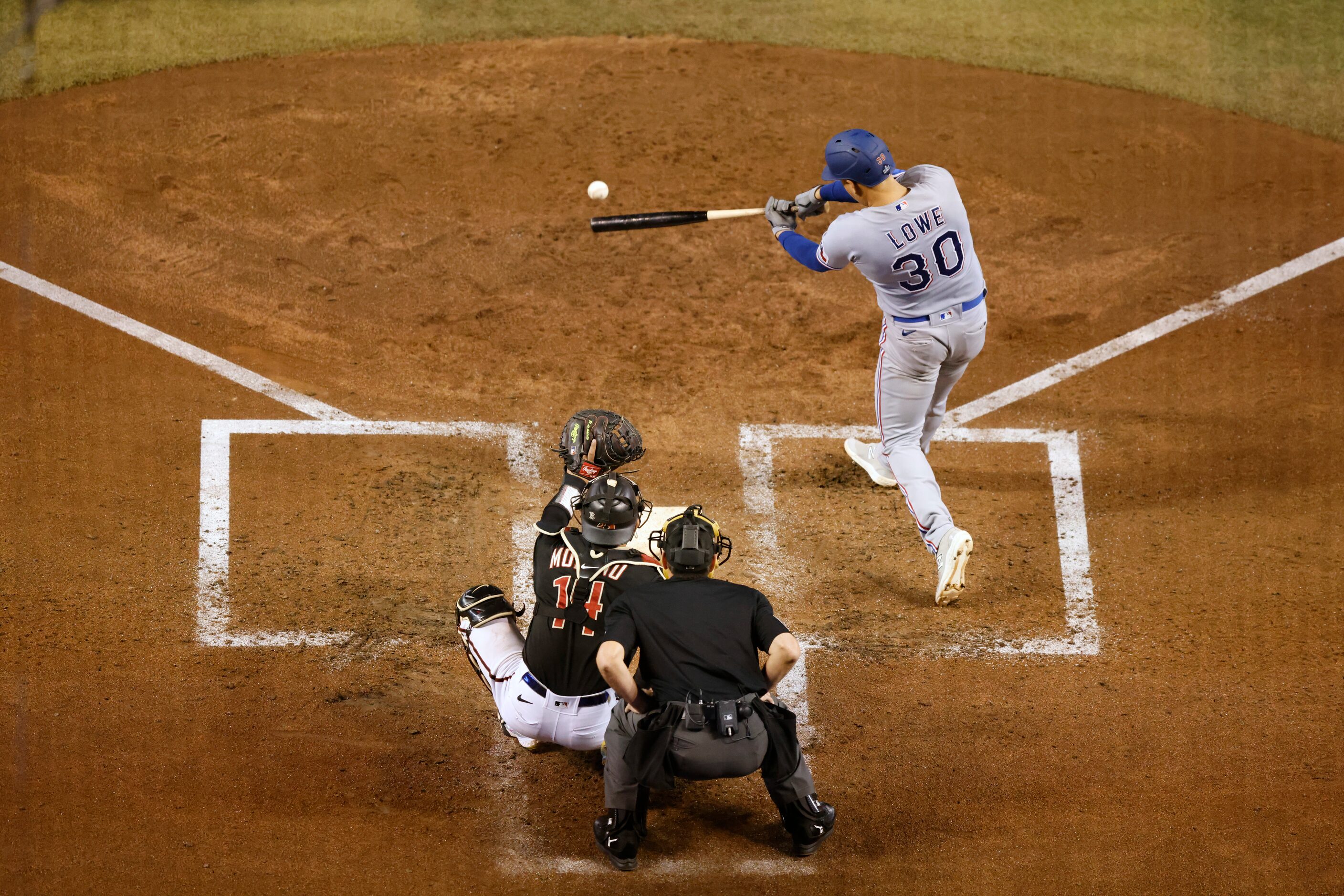 Texas Rangers’ Nathaniel Lowe connects for a single during the third inning in Game 4 of the...