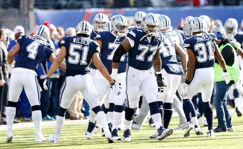 Dallas Cowboys offensive tackle Tyron Smith (77) greets teammates as the rest of the...